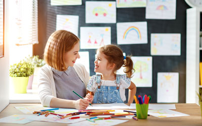 A child happily showcasing their creativity through art